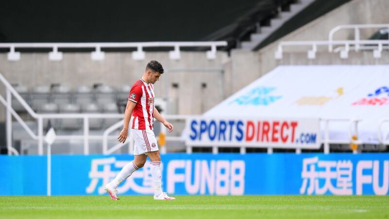 John Egan leaves the pitch after being sent off. Photo: Laurence Griffiths/Getty Images