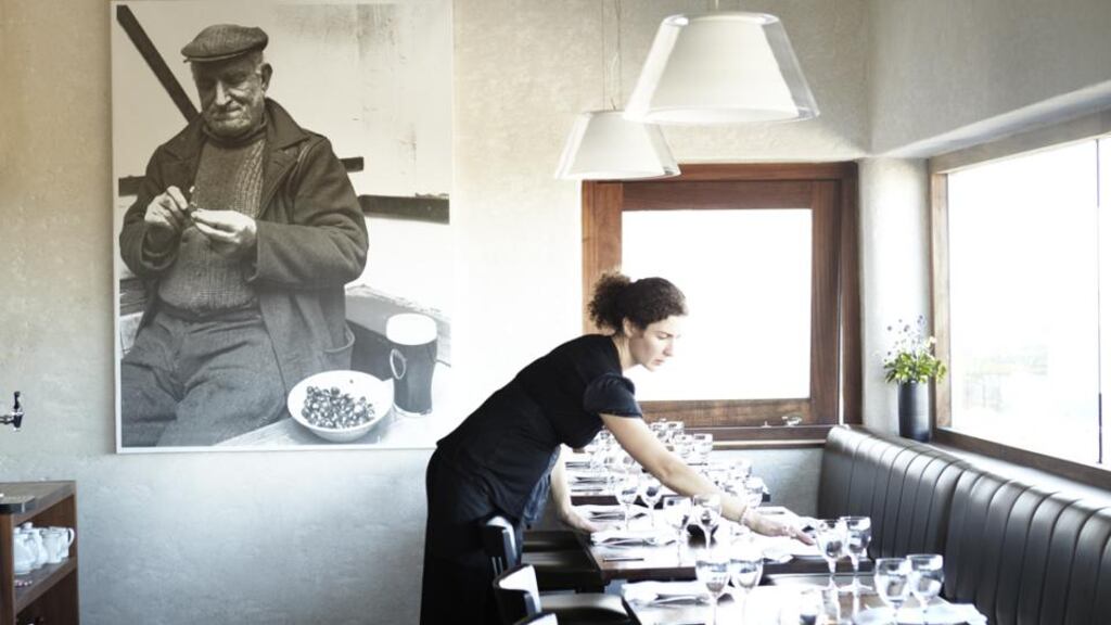 Marie-Thérèse de Blacam setting tables in the dining room in preparation for the new tourist season on Inis Meáin