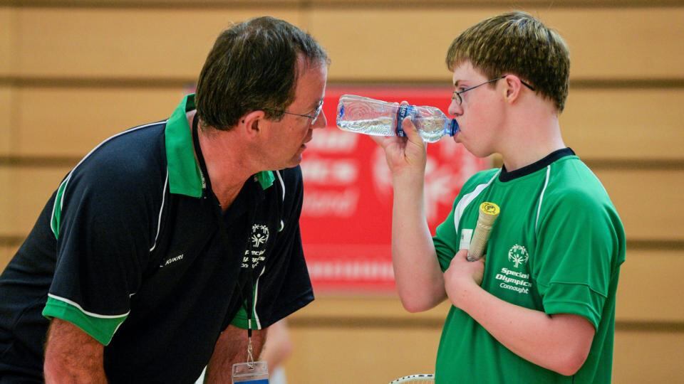 Badminton athlete Liam Foley from Moate in Co Westmeath gets some advice from his coach Tommy Hehir during half-time of his Division 8 game. Photograph: Diarmuid Greene/Sportsfile