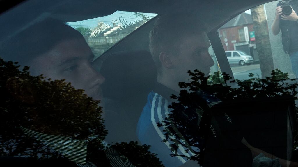 Mairtin Manning (wearing blue) was one of two men who were    brought before an out-of-hours sitting of the Special Criminal Court on Sunday evening. Photograph: Dave Meehan/The Irish Times