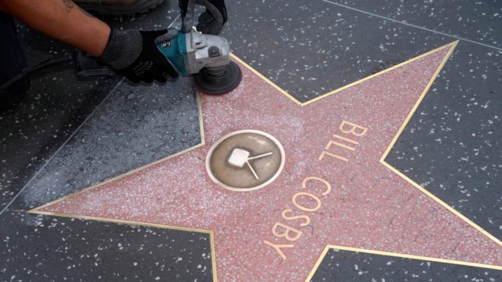 A worker cleans graffiti on actor Bill Cosby’s star on the Hollywood Walk of Fame in Los Angeles yesterday. Photograph: Reuters