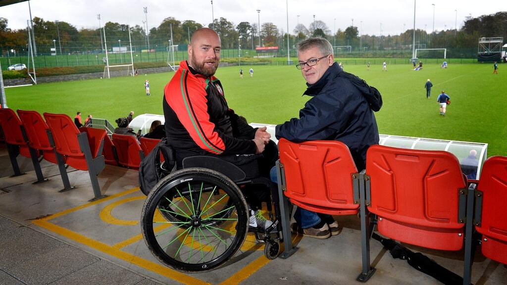 Former PSNI constable Peadar Heffron, who lost his leg in a terrorist attack, with with former GAA player and columnist Joe Brolly in Belfast during a PSNI v Garda match. Photograph: Presseye/Stephen Hamilton