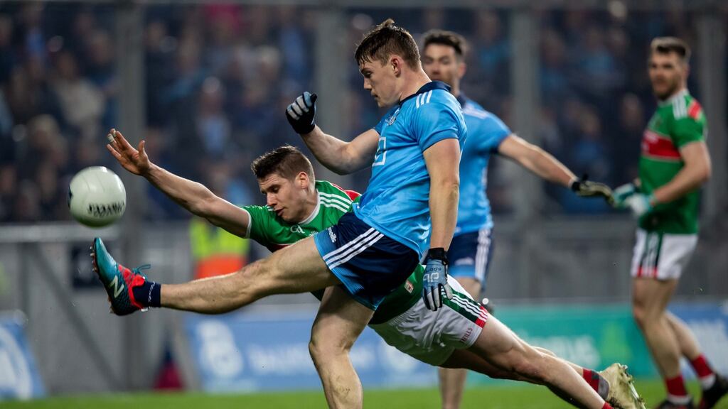 Dublin’s Con O’Callaghan gets his shot away despte the attempted block from Mayo’s Lee Keegan at Croke Park. Photograph: Morgan Treacy/Inpho