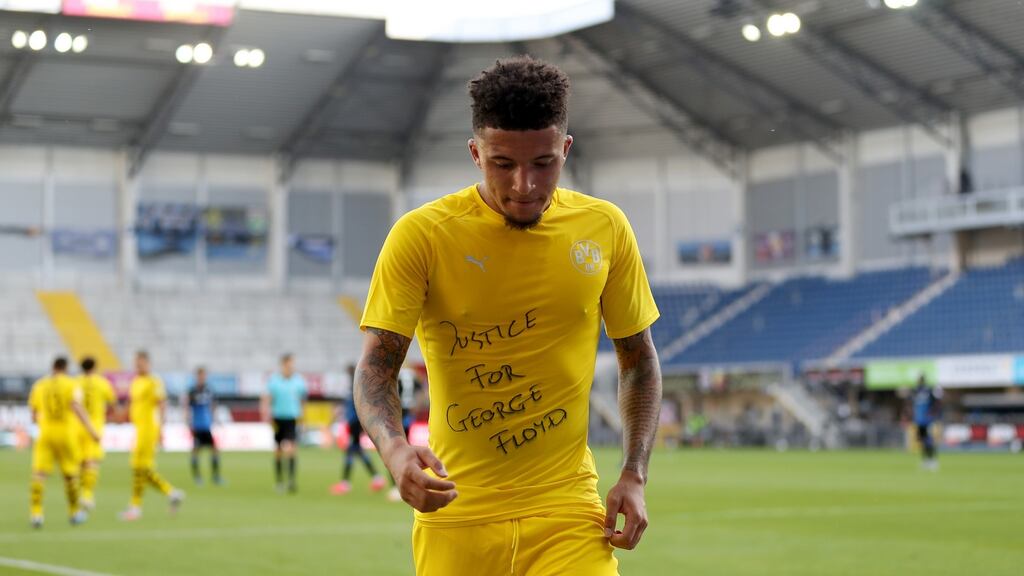 Borussia Dortmund’s England international Jadon Sancho celebrates scoring with a ‘Justice for George Floyd’ shirt during the Bundesliga match against SC Paderborn 07 at the Benteler arena in Paderborn. Photograph: Lars Baron/EPA