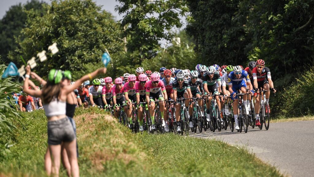 Spectators cheer as the peloton passes by during the fourth stage of the 2018 Tour de France between La Baule and Sarzeau in western France. Photograph: Marco Bertorello/AFP via Getty Images