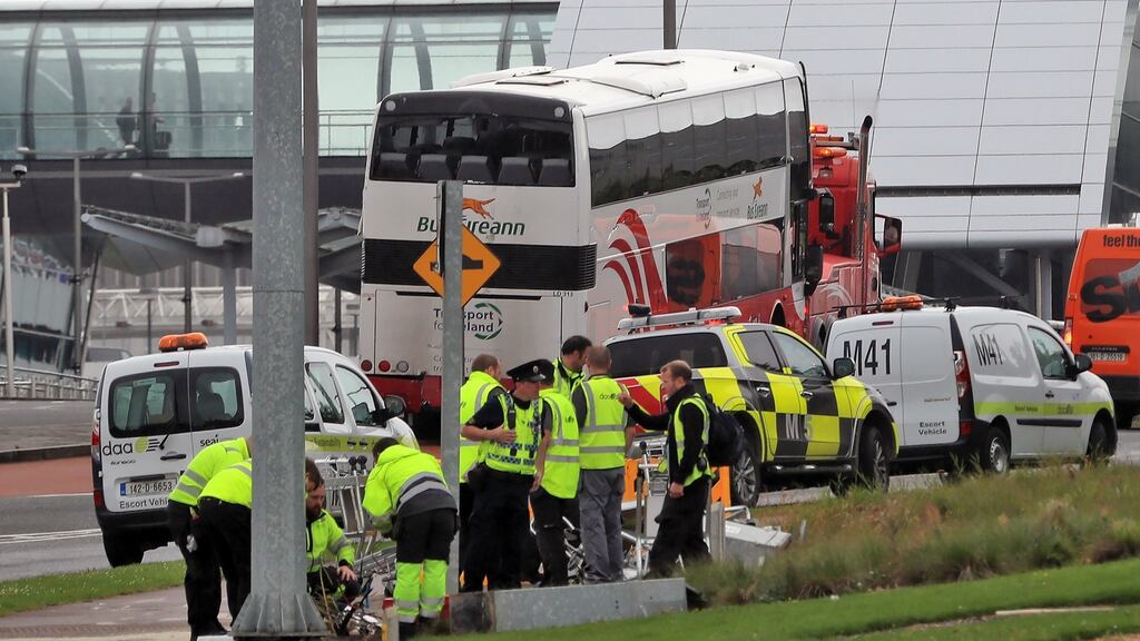 A Bus Éireann bus is removed from the scene outside T2 at Dublin Airport this morning after it rolled down a ramp  crashing into traffic lights. Photograph: Collins