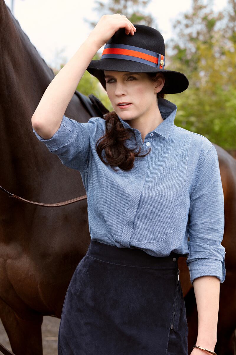 Rachael Blackmore: navy trilby, Holland Cooper, €99; navy houndstooth shirt with bib, Barbour, €46; navy suede zip detail wrap skirt, LK Bennett, €335; rose gold bangle, Calvin Klein from Hour Passion, €92