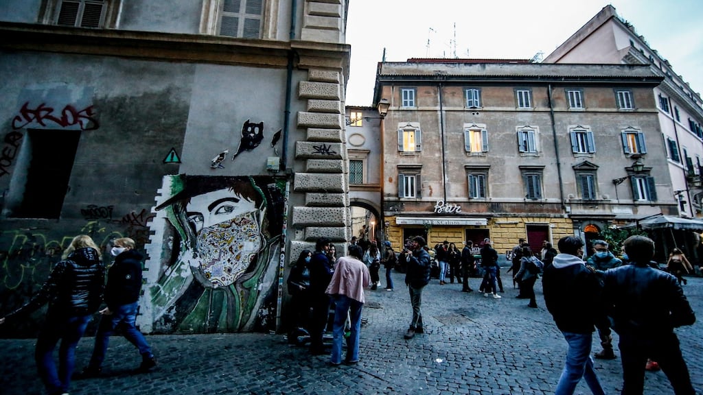 People crowd Piazza San Callisto, in Rome, Italy, as the region of Lazio enters lockdown due to soaring numbers of coronavirus infections. Photograph: Fabio Frustaci/EPA
