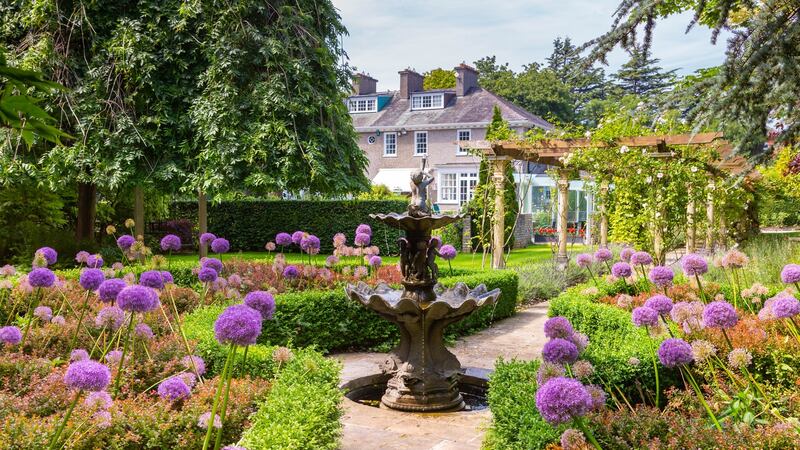 The grounds include lawns, wooded pathways, terraces, a glazed pavilion and even a putting green