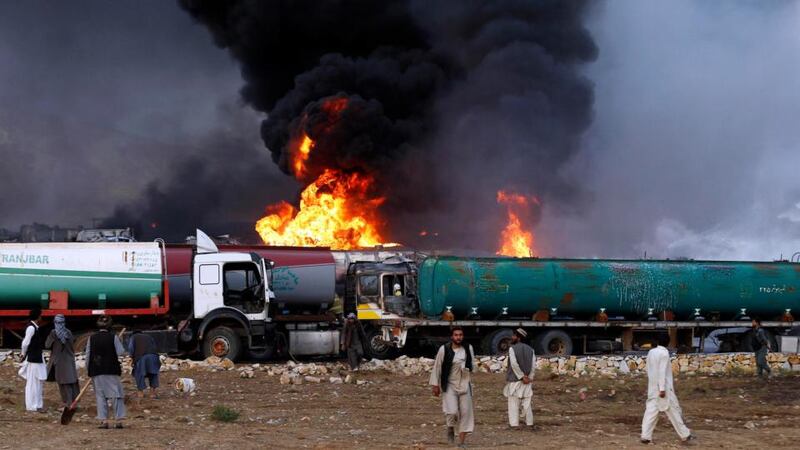 Smoke and flames rise from fuel trucks after the overnight attack. Photograph: Mohammad Ismail/Reuters