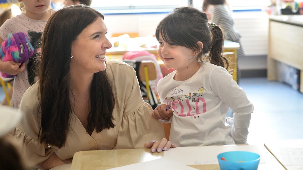 Teacher Christine Kelly, with Julia Fay in junior infants on her first day at school in Belmayne Educate Together National School, Belmayne, Dublin. Photograph: Dara Mac Dónaill / The Irish Times