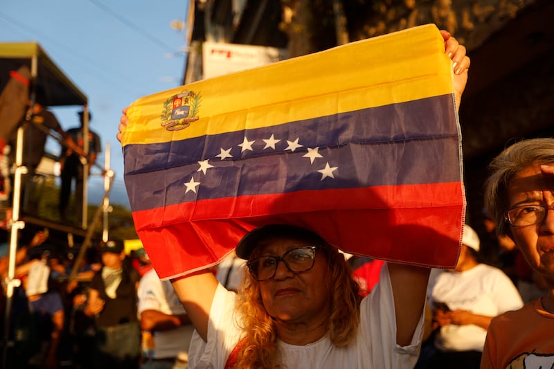 A supporter of venezuela's President Nicolas Maduro holds a Venezuelan flag during a rally against US and Trinidad and Tobago joint military exercises, in Caracas on October 28, 2025. Photograph: Pedro Mattey/Getty Images