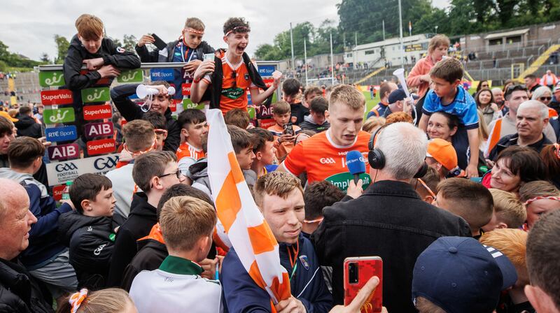 Rian O'Neill is interviewed after the game surrounded by Armagh supporters. Photograph: James Crombie/Inpho