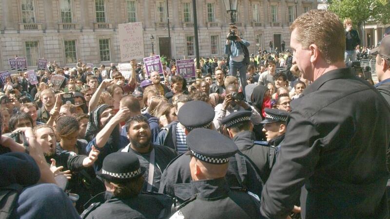 Kevin Carroll (right), co-founder and co leader of the EDL faces across a line of police UAF demonstrator outside Downing Street. Photograph: Max Nash/PA Wire