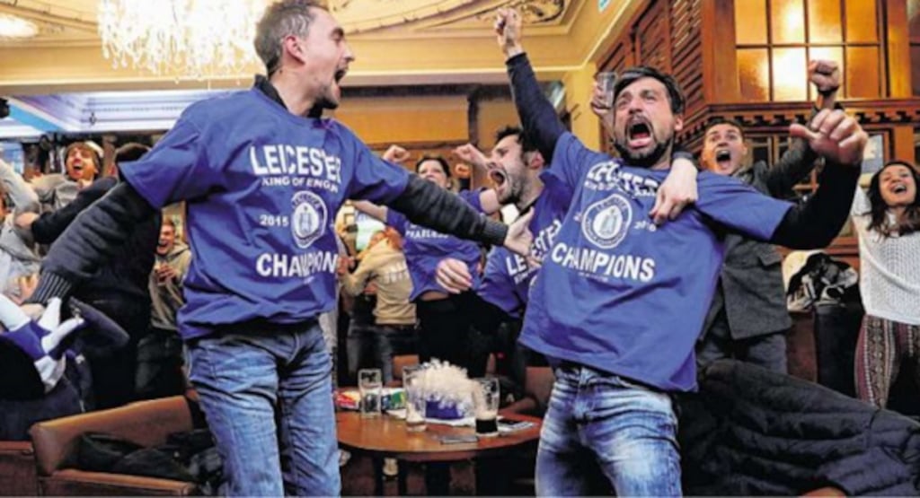 Leicester fans celebrate Chelsea's late equaliser against Tottenham Hotspur last night. The 2-2 draw at Stamford Bridge gave them their first league title. Photograph: Eddie Keogh/Reuters