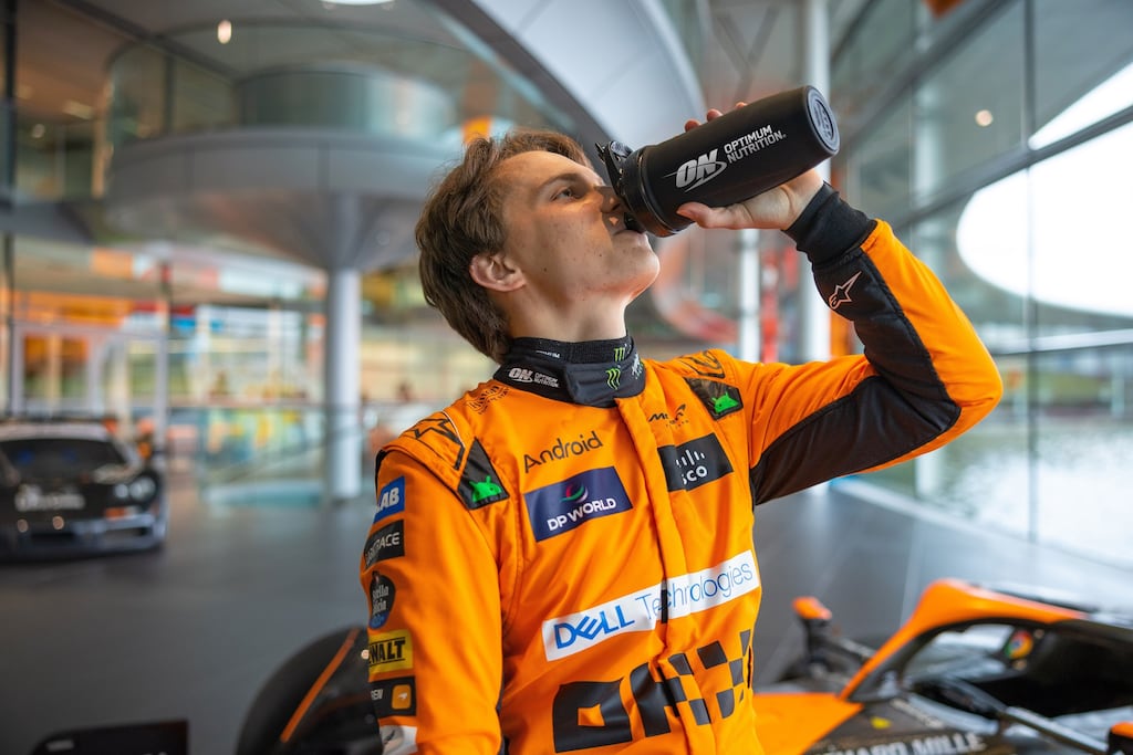 McLaren Formula One driver Oscar Piastri drinking Glanbia’s top-selling Optimum Nutrition brand.