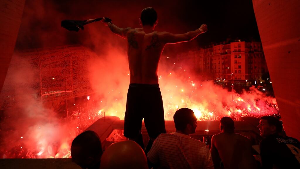 Angel Di Maria of Paris Saint-Germain celebrates victory with fans outside the stadium after last Wednesday’s Champions League match against Borussia Dortmund in Paris, played behind closed doors. Photograph: Getty