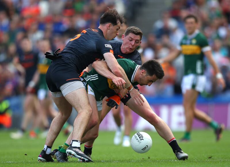 Armagh's Barry McCambridge and Paddy Burns tackle Brian Ó Beaglaoich of Kerry. Photograph: Leah Scholes/Inpho