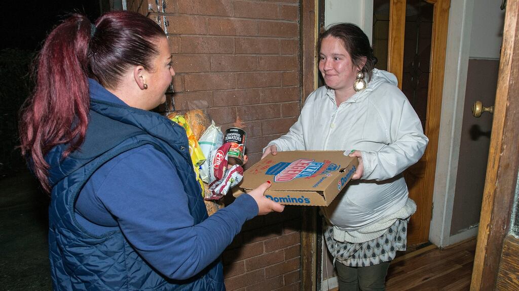 Volunteer Yvonne Byrne delivering food to Selina Hall at her home in Ballyfermot in west Dublin. Photograph: Dave Meehan.