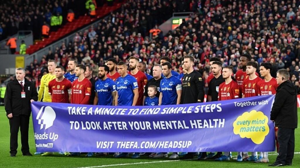 Everton and Liverpool players pose with a mental health banner before their FA Cup third round match at Anfield. Photograph: Getty Images