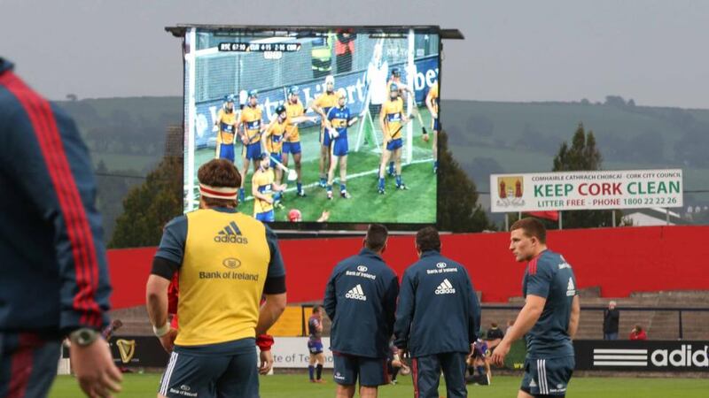 Munster head coach Rob Penney and manager Niall O’Donovan watch the All-Ireland hurling final replay before last week’s Rabo Pro12 match against the Dragons. Photograph: Billy Stickland/Inpho