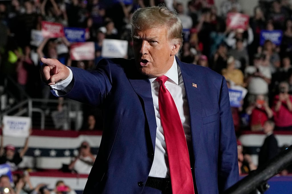 Former President Donald Trump arrives for a campaign rally on Wednesday following his indictment (AP)