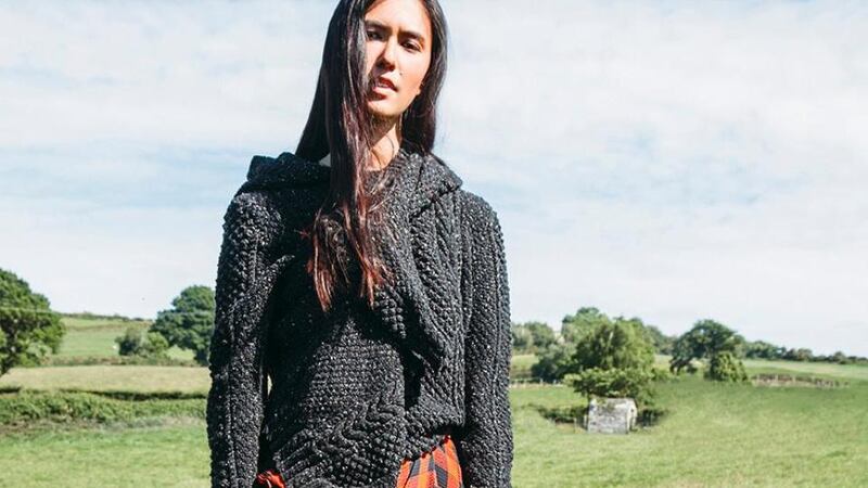 Grey hooded knit jumper €567, grey cable knit cardigan €513, both from Faye Dinsmore. Red checked midi skirt €700 from Preen.