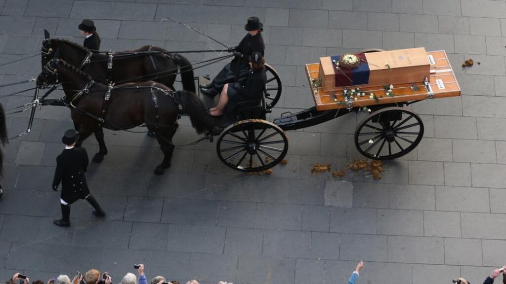 People throw white roses on to the coffin containing the remains of King Richard III as it is carried in procession for interment at Leicester Cathedral on March 22, 2015 in Leicester, England. Photograph: Christopher Furlong/Getty Images