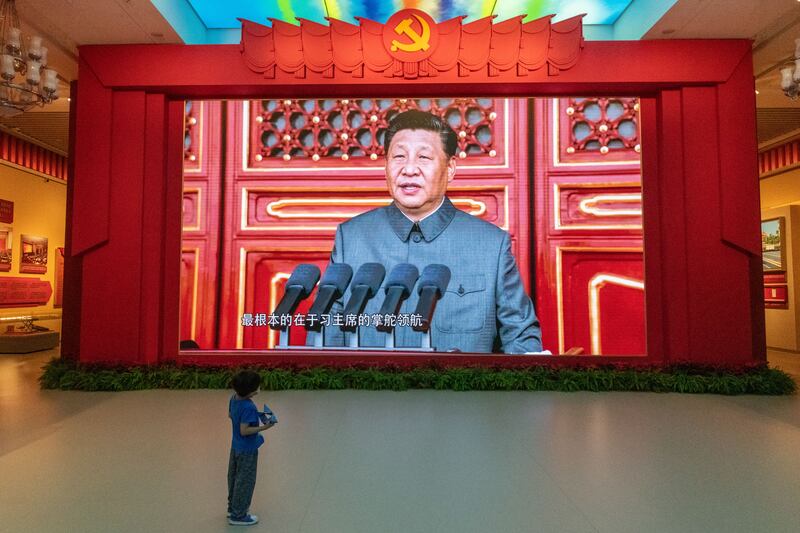 A youth watches a giant screen showing President Xi Jinping of China, at the Military Museum in Beijing. Photograph: Gilles Sabrié/New York Times