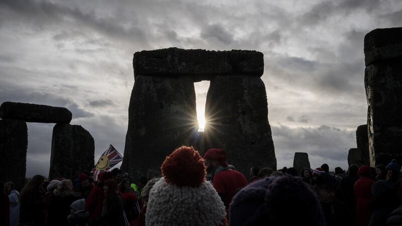 People look towards the sun as druids, pagans and revellers gather at Stonehenge, hoping to see the sun rise, as they take part in a winter solstice ceremony at the ancient neolithic monument of Stonehenge near Amesbury in Wiltshire, England. Photograph: Matt Cardy/Getty Images