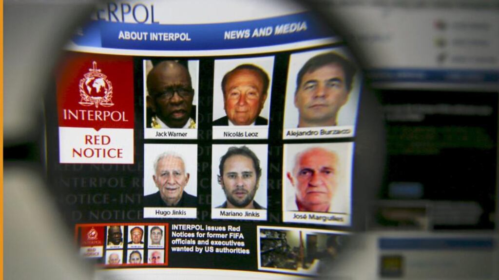 The homepage of the Interpol website seen through a magnifying glass on June 3rd, 2015. Interpol said on Wednesday it has issued international wanted-person alerts for two former Fifa officials including Jack Warner and four corporate executives at the request of US authorities. Photograph: Pawel Kopczynski/Reuters