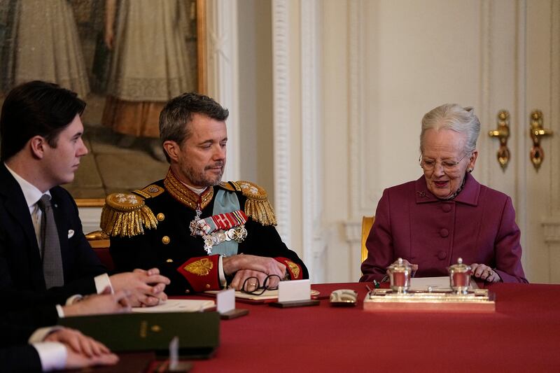 Queen Margrethe II of Denmark signs the declaration of abdication in the presence of King Frederik X of Denmark and Prince Christian. Photograph: Mads Claus Rasmussen/AFP
