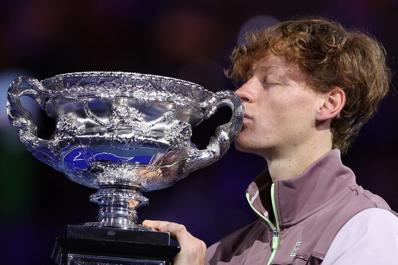 Italy's Jannik Sinner kisses the Norman Brookes Challenge Cup after winning the Australian Open. Photograph: Martin Keep/AFP via Getty Images