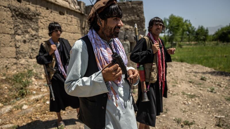 Commander Wahidullah Zindani (centre) and Muhammad Agha Bambard (right) at their outpost near Mehtar Lam, Afghanistan. Photograph: Jim Huylebroek/The New York Times
