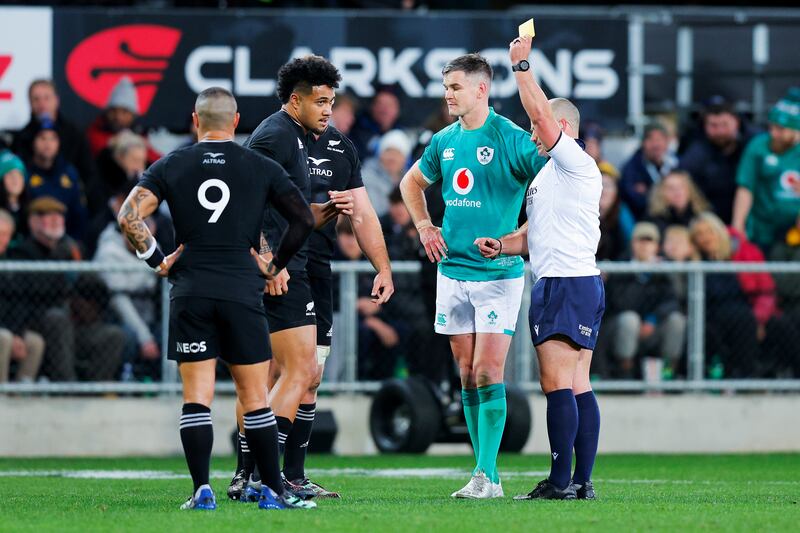 Referee Jaco Peyper of South Africa shows Leicester Fainga’anuku of New Zealand a yellow card against Ireland. Photograph: Hagen Hopkins/Getty