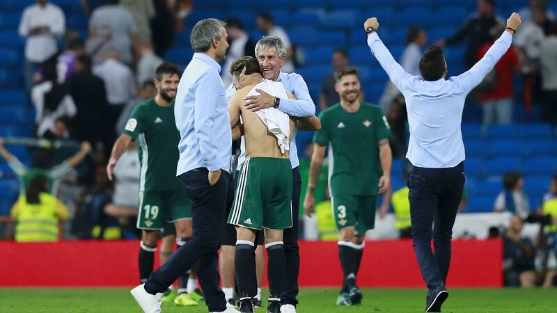 Real Betis coach Quique Setien celebrates with his players after the win over Real Madrid. Photograph: Gonzalo Arroyo Moreno/Getty Images