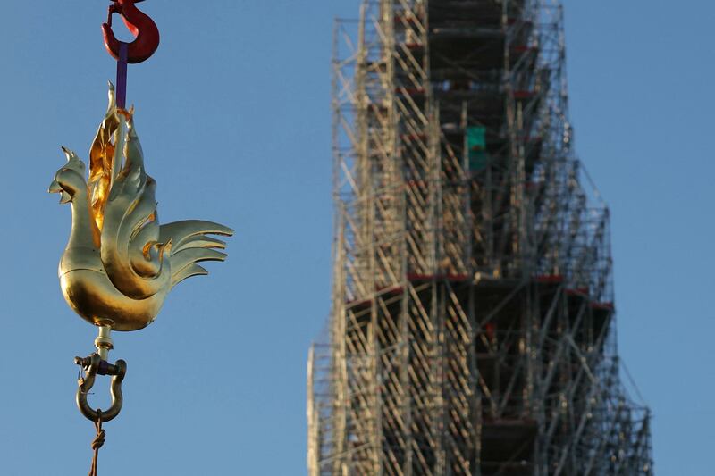 Notre-Dame: the phoenix-like cockerel weathervane being lifted to the top of the reconstructed spire. Photograph: Thomas Samson/AFP via Getty Images