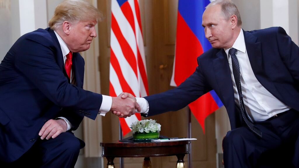 File photo:  US president Donald Trump, (left) shakes hands with Russian resident Vladimir Putin, at their previous formal sit-down meeting in Helsinki, Finland taken on July 16th, 2018  Photograph: Pablo Martinez Monsivais/AP/ File