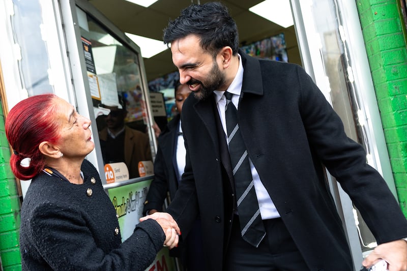 Mamdani greets a woman as he prepares to speak in the Belmont neighborhood of the Bronx on October 29th. Photograph: Michael M Santiago/Getty Images