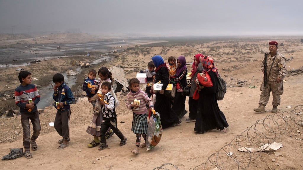People displaced by the fighting near Mosul pass a checkpoint in Qayyara, 50km south of Mosul. The combat ahead is likely to get more deadly as 1.5 million residents remain in Mosul. Photograph: Marko Drobnjakovic/AP