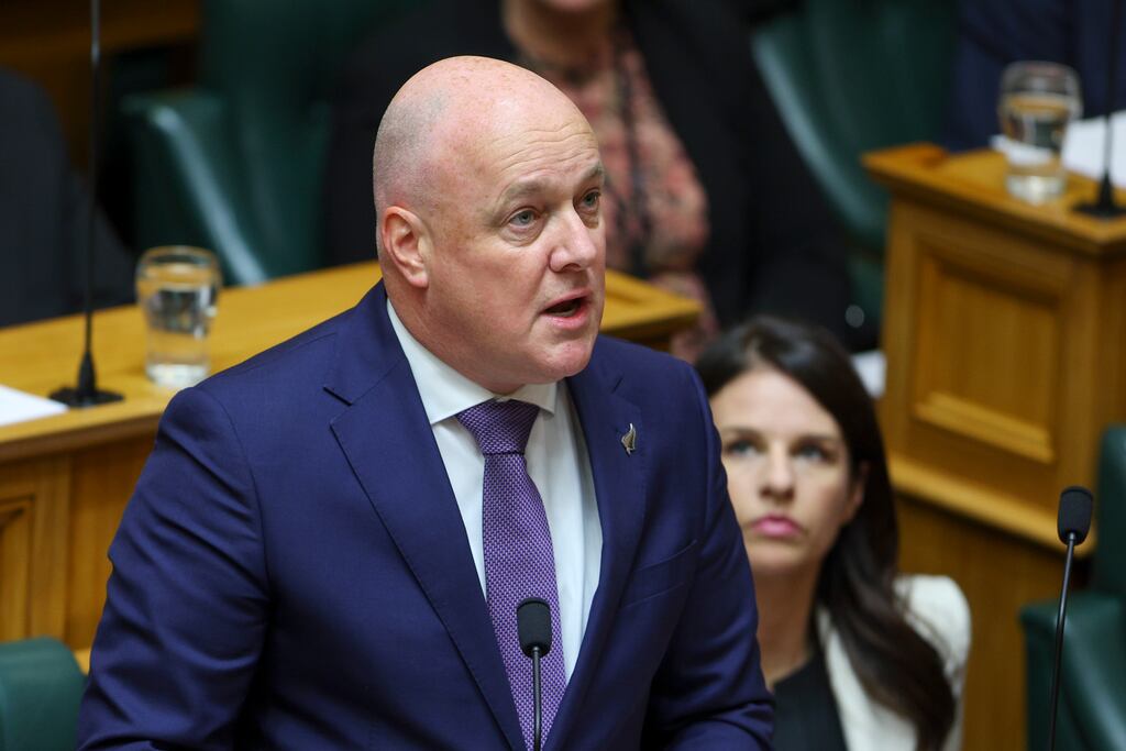Prime minister Christopher Luxon speaks while government minister Erica Stanford looks on during the release of the report into abuse in care in the New Zealand parliament in Wellington on Wednesday. Photograph: Hagen Hopkins/Getty Images