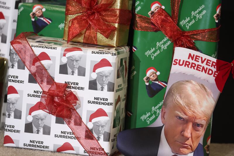 Gifts in Christmas wrapping paper featuring the likeness of Donald Trump sit on the stage during a rally hosted by the former US president in Waterloo, Iowa on December 19th, 2023. Photograph: Scott Olson/Getty Images