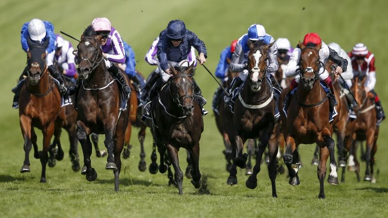 Padraig Beggy riding Wings Of Eagles (2L, pink cap) win The Investec Derby from Cliffs Of Moher (C, dark blue). Photograph: Alan Crowhurst/Getty Images