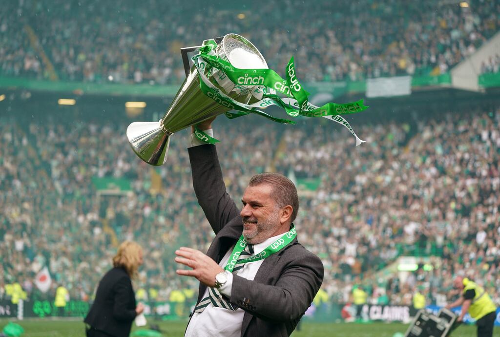 Celtic manager Angelos Postecoglou celebrates with the league trophy after the cinch Premiership match at Celtic Park, Glasgow. Photograph: Andrew Milligan/PA Wire