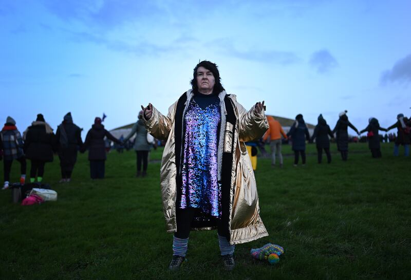 New Age revellers and sun worshippers celebrate the Winter Solstice as the sun rises over Newgrange. Photograph: Charles McQuillan/Getty Images