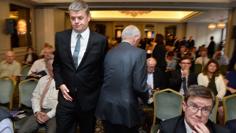 INM chief executive Robert Pitt (left) walks past chairman Leslie Buckley at the INM AGM in Dublin. Photograph: Dara Mac Dónaill