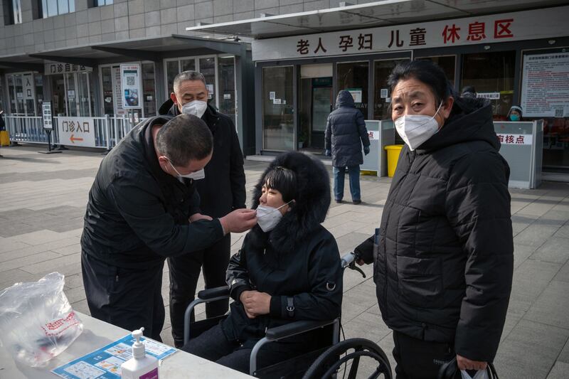 People perform Covid rapid antigen tests before entering a hospital in Beijing on Wednesday. Photograph: Bloomberg