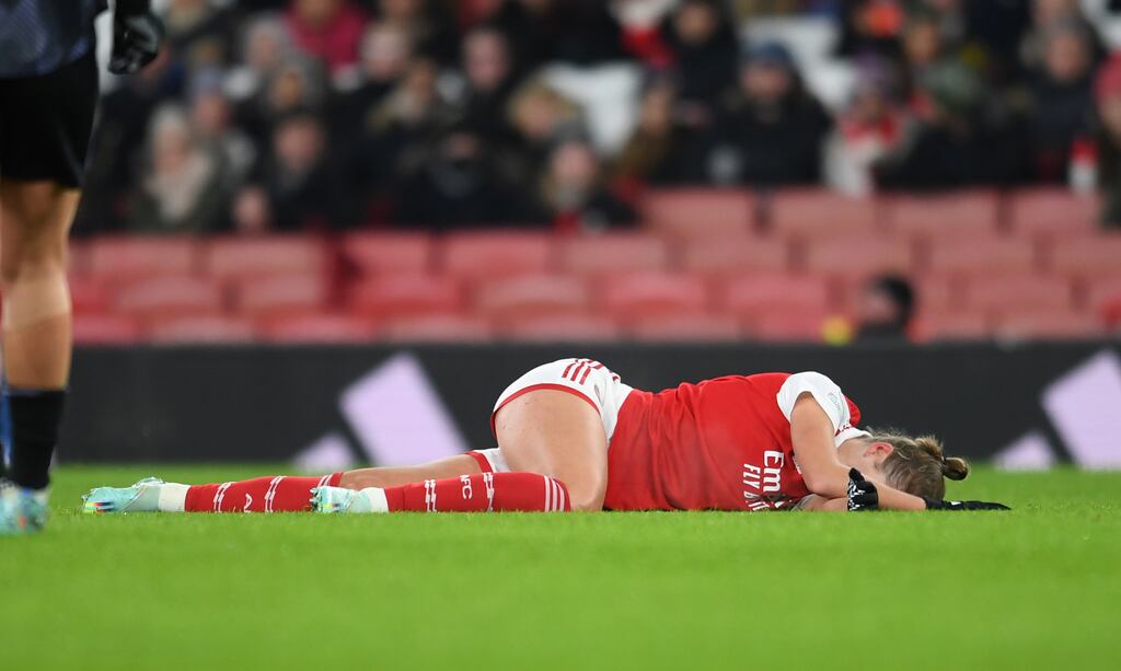 Vivianne Miedema of Arsenal and the Netherlands lies in pain on the pitch after rupturing her ACL in a Champions League match in December 2022. Photograph: David Price/Arsenal FC via Getty Images