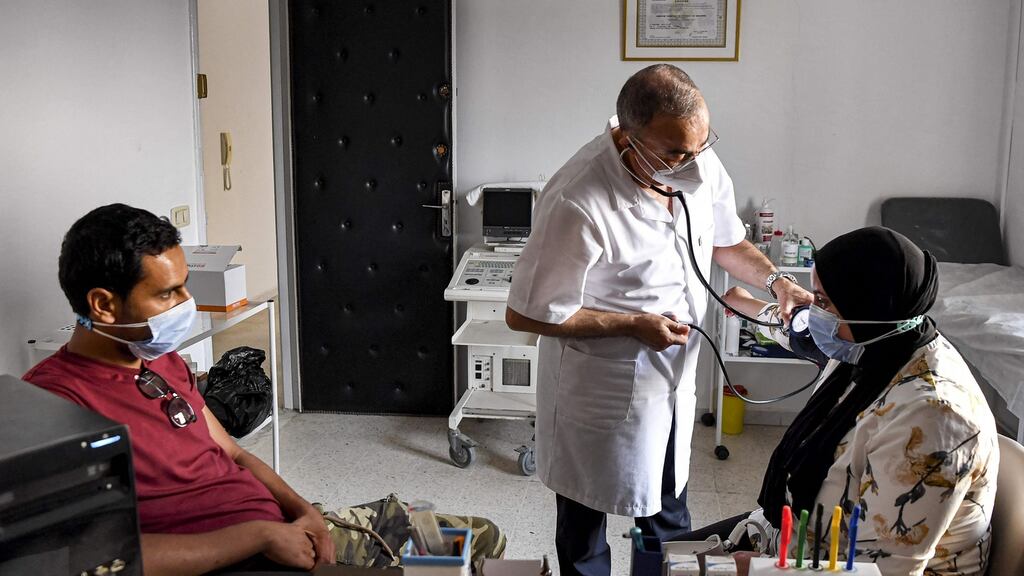 A doctor measures the blood pressure of a patient at a clinic in the town of Bou Mhel, Tunisia. Some hospitals are experiencing shortages of oxygen, which is crucial for Covid-19 patients with breathing difficulties. Photograph: Fethi Belaid/AFP via Getty Images