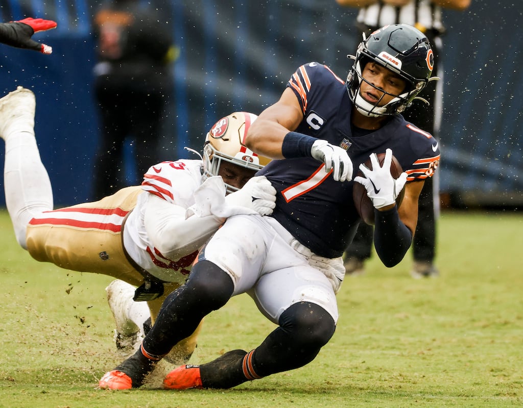 Chicago Bears quarterback Justin Fields (R) is tackled by San Francisco 49ers defensive end Drake Jackson (L) during the NFL game between the San Francisco 49ers and the Chicago Bears at Soldier Field in Chicago. The NFL is one of the competitions covered by ASX.